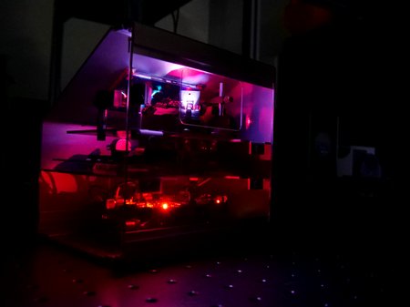 A MEMS Micromirror which is glowing red and purple