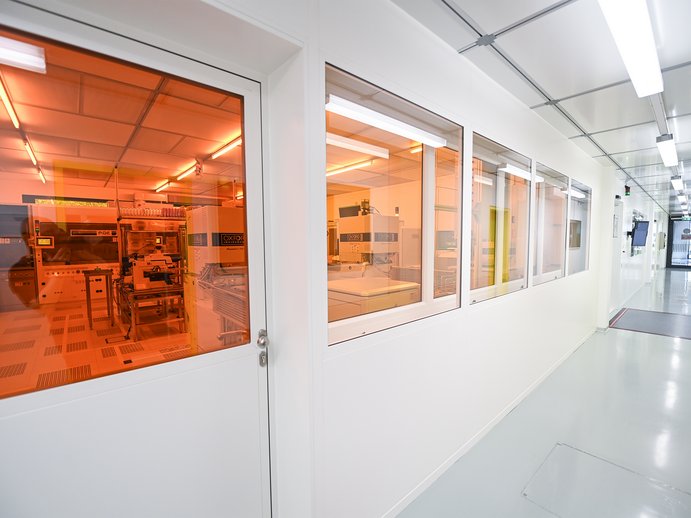 Hallway with windows into a research cleanroom