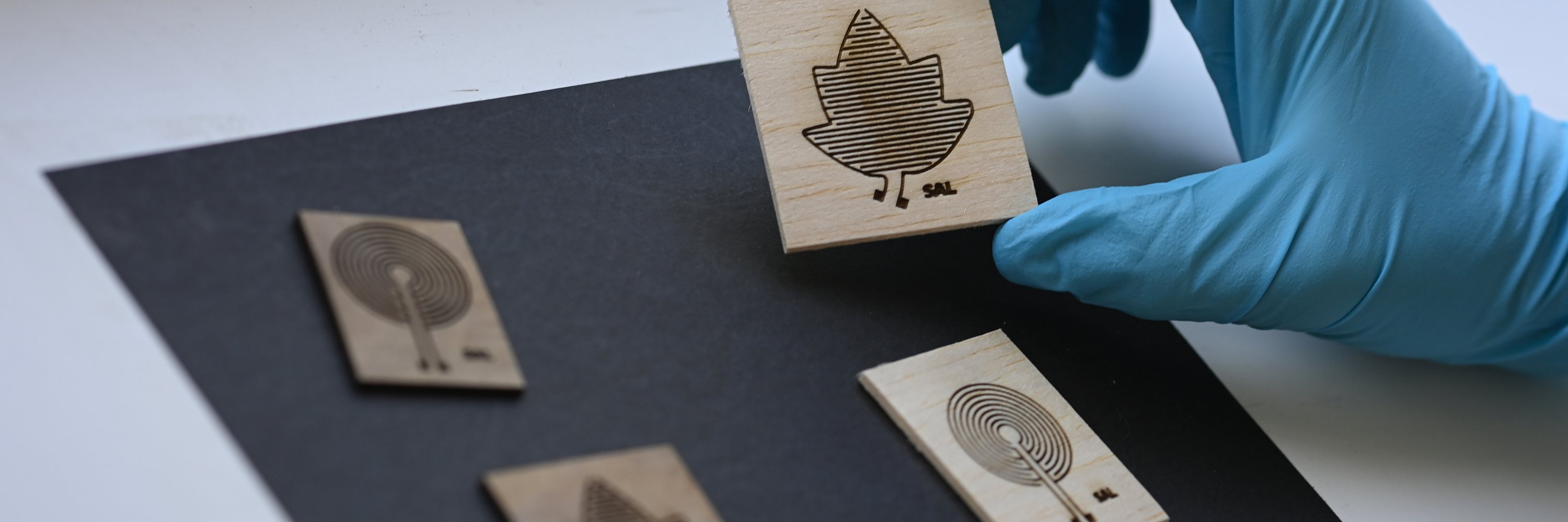 four pieces of wood printed with electronics