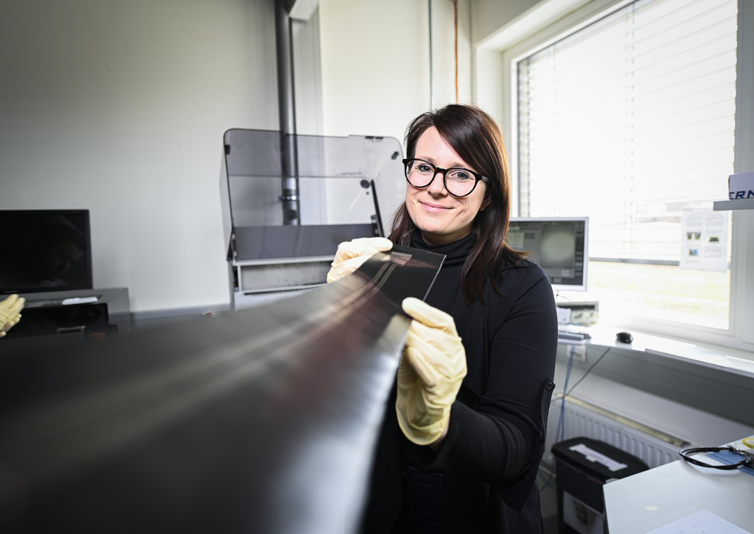 Johanna Zikulnig is holding a printed sensor in her hands