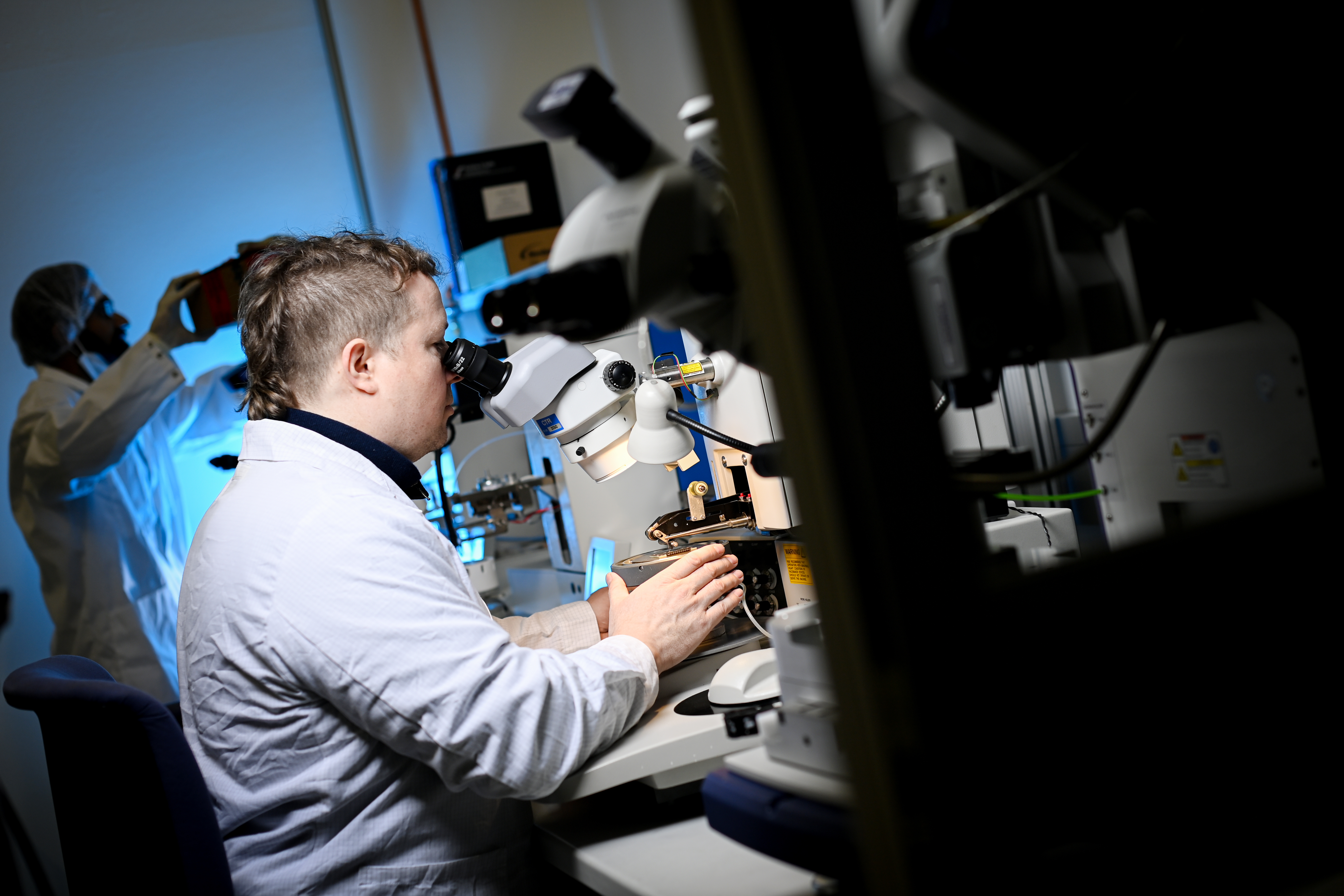 Forscher schaut durch ein Mikroskop in einem Labor