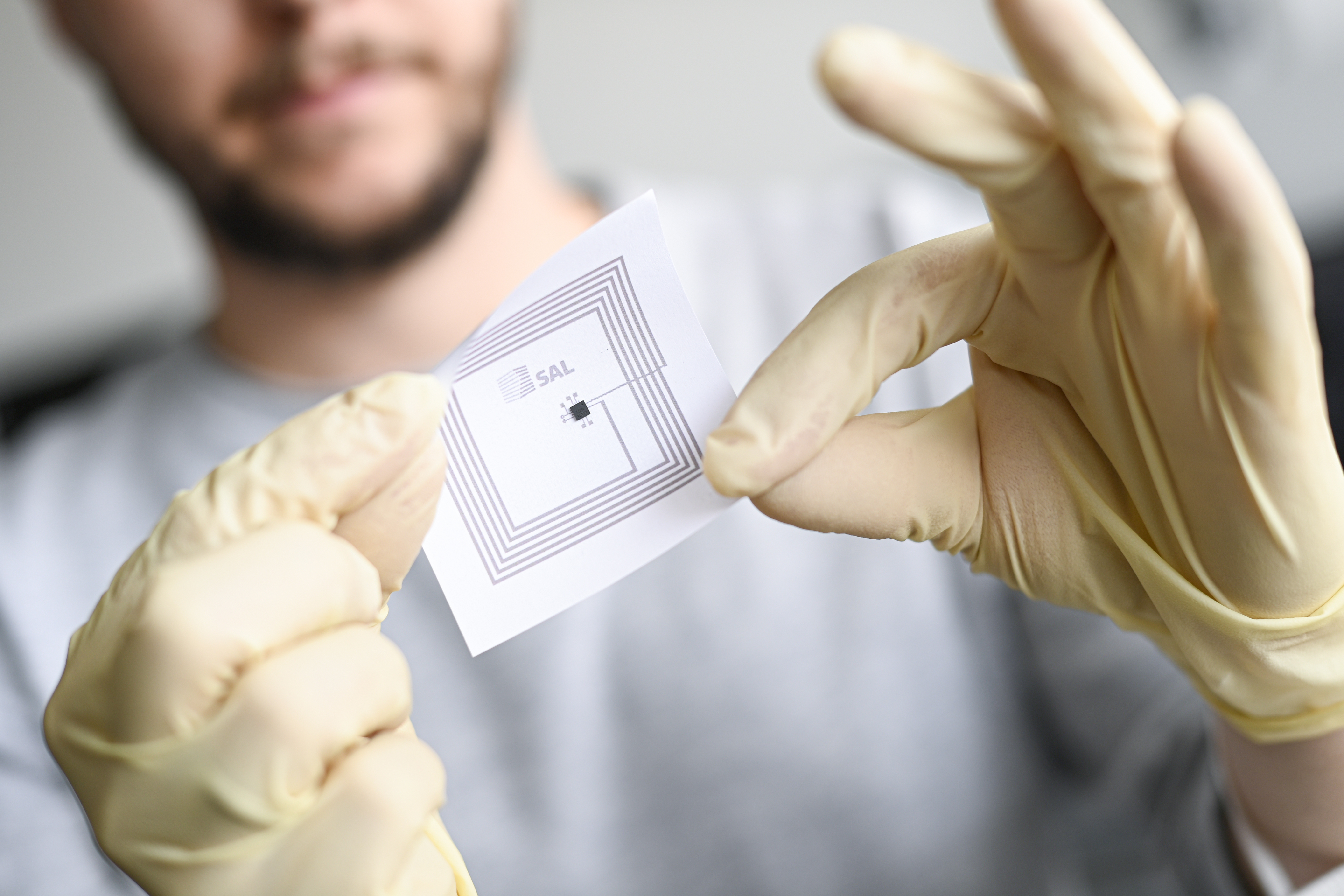 close-up of a printed sensor in the hands of a researcher
