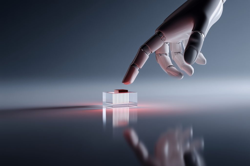 Roboterfinger setzt KI-Chip in durchsichtige Fassung ein